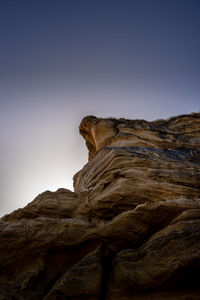 Low angle view of rock formation against clear sky