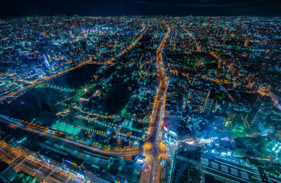 Aerial view of illuminated buildings in city at night