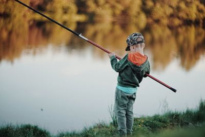 Full length of man fishing in lake