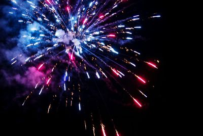 Low angle view of firework display at night