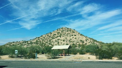Built structure on landscape against blue sky