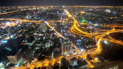 High angle view of illuminated city buildings at night