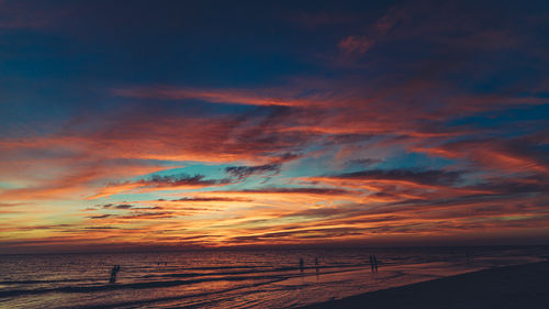 Scenic view of beach against sky during sunset