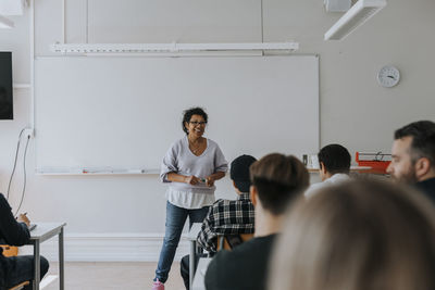 Smiling teacher teaching in classroom