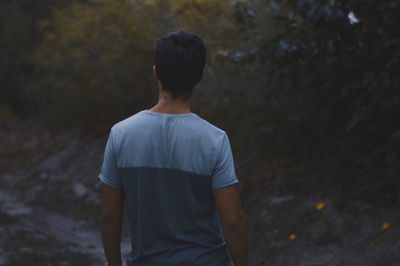 Rear view of a man standing outdoors