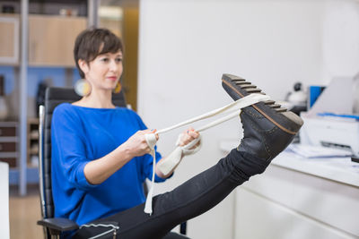 Side view of woman exercising in gym