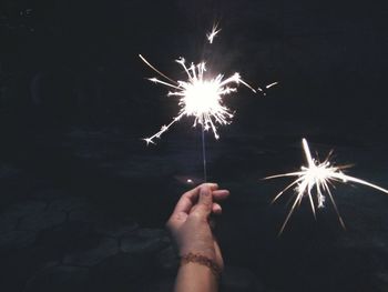 Low angle view of firework display at night