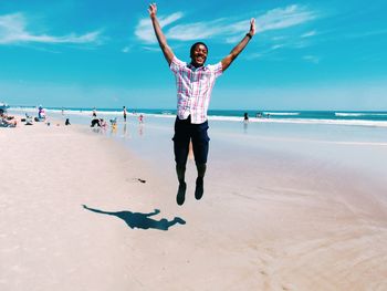 Full length of boy on beach against sky