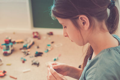 Close-up of girl playing jigsaw puzzle