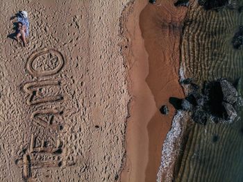 Tilt image of painting on sand