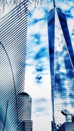 Low angle view of modern building against cloudy sky