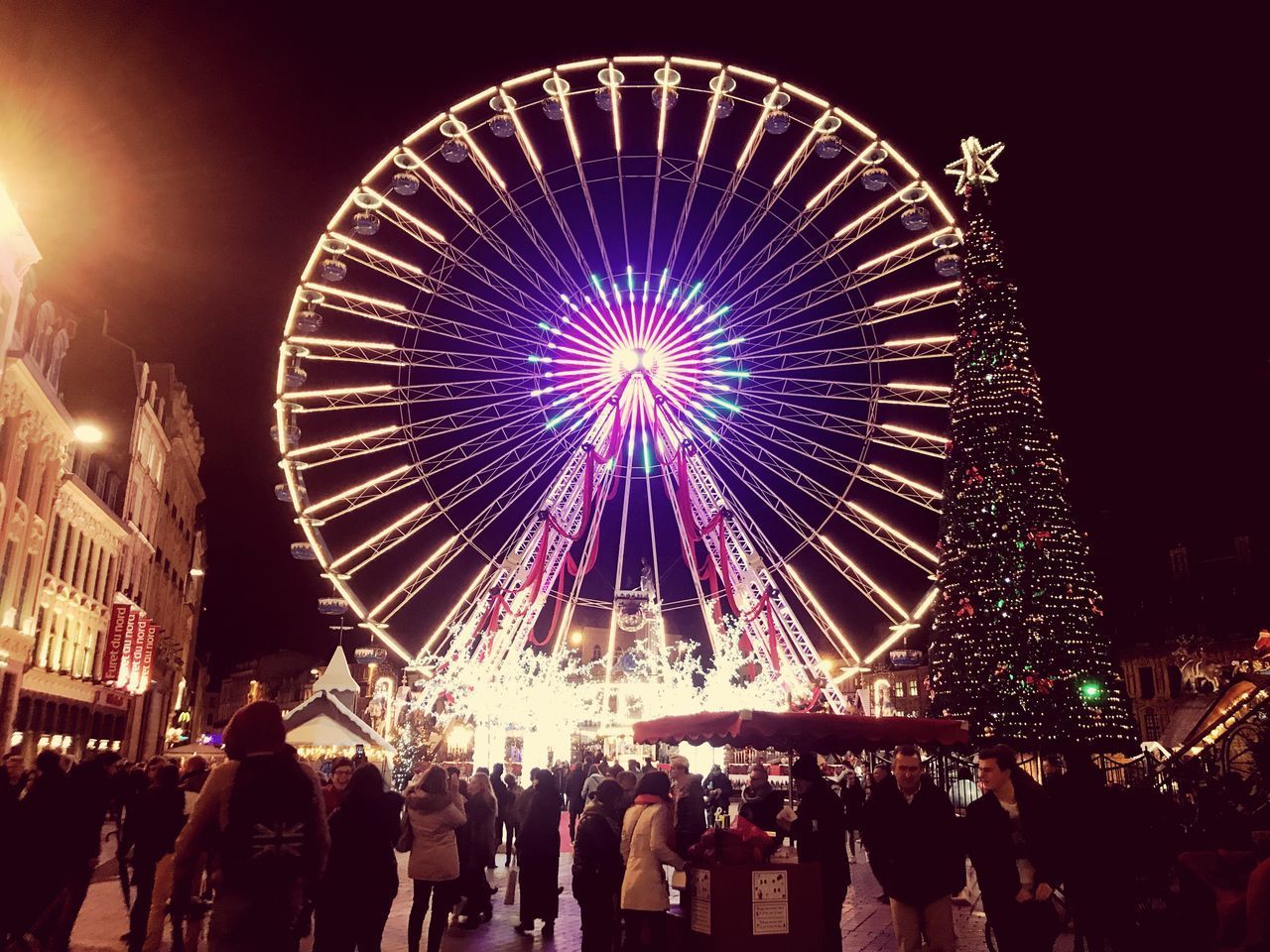 LOW ANGLE VIEW OF ILLUMINATED FERRIS WHEEL AGAINST SKY