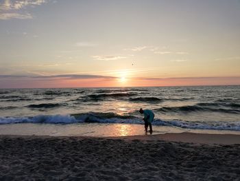 Scenic view of beach against sky during sunset