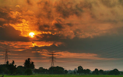 Silhouette trees against sky during sunset