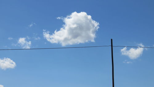 Silhouette of power line and cable against sky