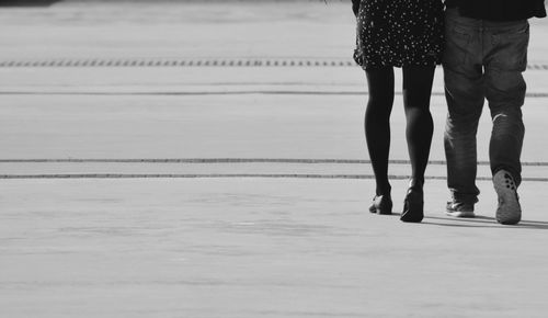 Low section of people standing on tiled floor