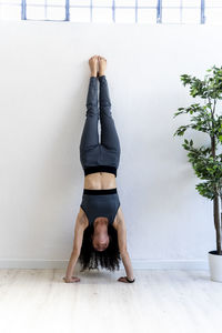 Woman doing handstand at home