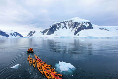 Scenic view of frozen lake against mountain range