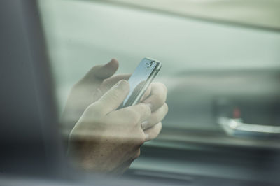 Close-up of woman hand using mobile phone