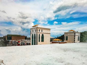 Building in town against cloudy sky