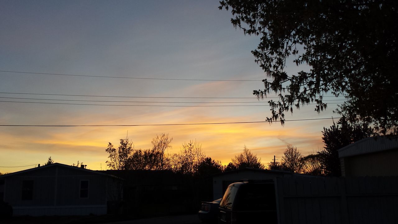 building exterior, sunset, built structure, architecture, sky, house, silhouette, tree, low angle view, cloud - sky, residential structure, cloud, nature, outdoors, orange color, no people, residential building, roof, beauty in nature, power line