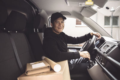 Portrait of smiling man sitting in car