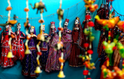 Colorful puppets hanging at market for sale