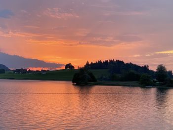 Scenic view of lake against sky during sunset