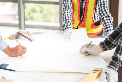 Cropped image of architecture guiding colleagues while working