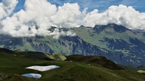 Scenic view of mountains against cloudy sky