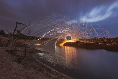 Scenic view of lake against sky at night