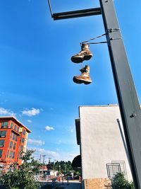 Low angle view of person jumping against buildings