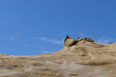 Low angle view of rock formations against sky