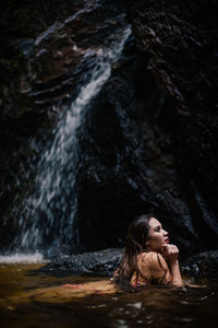 Full length of woman standing on rock