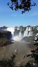 Scenic view of waterfall against sky