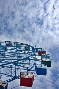 Low angle view of ferris wheel against sky