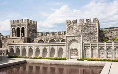 Buildings against cloudy sky