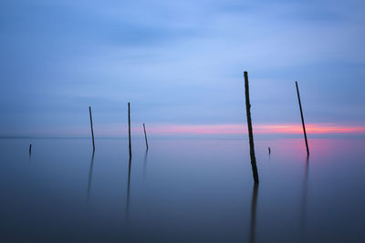 Scenic view of lake against sky at sunset