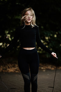 Full length of a smiling girl standing on land doing road skipping