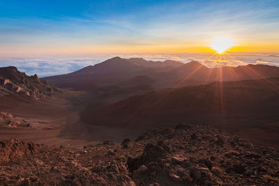 Scenic view of mountains against sky during sunset