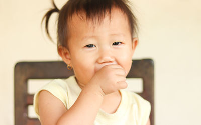 Close-up portrait of cute boy at home