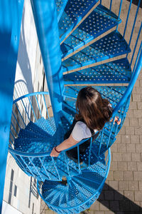 Rear view of girl on staircase