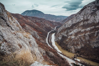 Scenic view of mountains against cloudy sky