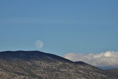 Low angle view of mountains against blue sky