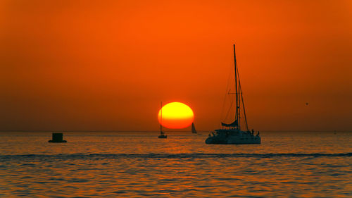 Silhouette of sailboat in sea