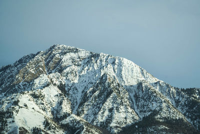 Scenic view of snowcapped mountains against clear sky