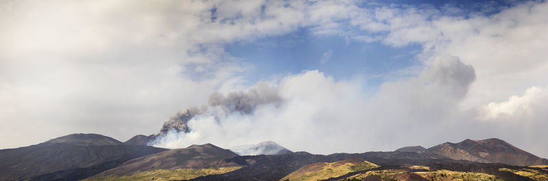 Panoramic view of volcanic mountains against sky