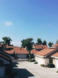 Houses and buildings against blue sky