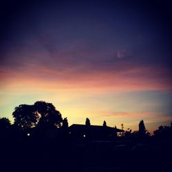 Silhouette of trees against sky at sunset