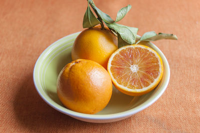 High angle view of fresh organic orange on bowl on table